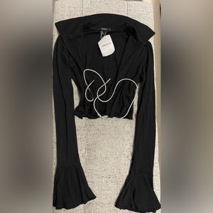 Long sleeve black shirt and pants with diamond ties in front.